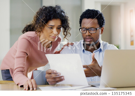 Couple, document and finance for debt, bills or planning expenses together in the kitchen at home. Serious African man and woman working on paperwork in financial crisis, mortgage or investment plan Couple, document and finance for debt, bills or planning expenses together in the kitchen at home. Serious African man and woman working on paperwork in financial crisis, mortgage or investment plan 135175345