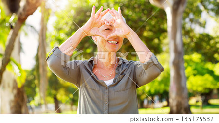 Portrait, heart hands and a woman in a park for summer, retirement break and calm in Australia. Happy, care and a senior person with a shape gesture to show love, happiness and support in nature 135175532