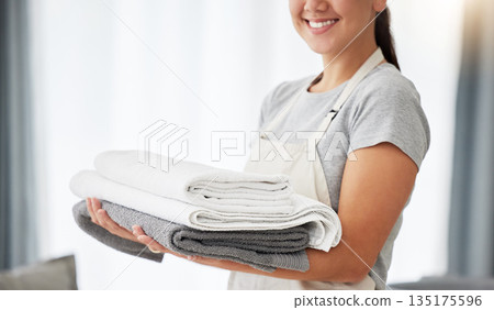 Towel, cleaner and hands of woman with pile of clean laundry, washing linen or hotel room service. Person, maid or routine cleaning of a fresh stack of towels, washed fabric or mockup space at home Towel, cleaner and hands of woman with pile of clean laundry, washing linen or hotel room service. Person, maid or routine cleaning of a fresh stack of towels, washed fabric or mockup space at home 135175596