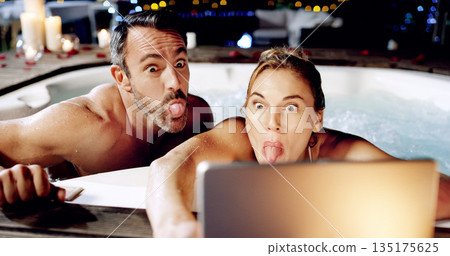 Tablet, spa and crazy couple take selfie with tongue for social media or the internet or online for a romantic night date. Celebration, web or funny face by people on vacation or holiday in a hot tub Tablet, spa and crazy couple take selfie with tongue for social media or the internet or online for a romantic night date. Celebration, web or funny face by people on vacation or holiday in a hot tub 135175625