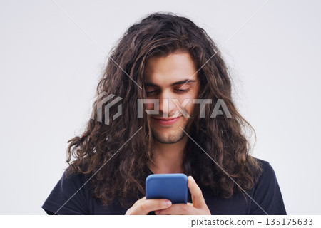 Phone, typing and face of man in studio for social media post, internet and online chat. Communication, white background and happy male person on smartphone for website, mobile app and networking Phone, typing and face of man in studio for social media post, internet and online chat. Communication, white background and happy male person on smartphone for website, mobile app and networking 135175633