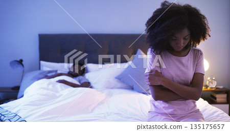 Black couple, bedroom and sad woman at night thinking of divorce, stress or depression. Man sleeping in home bed with partner upset about fight, marriage and erectile dysfunction or cheating secret Black couple, bedroom and sad woman at night thinking of divorce, stress or depression. Man sleeping in home bed with partner upset about fight, marriage and erectile dysfunction or cheating secret 135175657