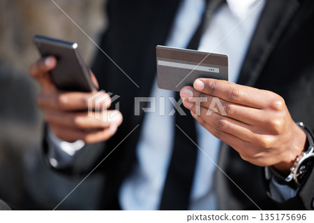 Hands, phone and a credit card for an online payment, shopping or ecommerce. Contact, finance and closeup of a businessman on a mobile app for banking, investing money and paying on the internet 135175696