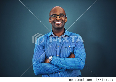 Business, black man and portrait with arms crossed in a studio feeling proud from auditor work. Blue background, smile and African employee with success and leadership vision with glasses and idea Business, black man and portrait with arms crossed in a studio feeling proud from auditor work. Blue background, smile and African employee with success and leadership vision with glasses and idea 135175725