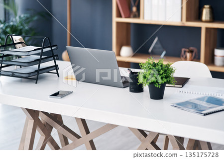 Office desk, business workspace and laptop with professional setup at digital marketing startup. Workstation, paperwork and notebook with work supplies, technology and pc on table in empty workplace Office desk, business workspace and laptop with professional setup at digital marketing startup. Workstation, paperwork and notebook with work supplies, technology and pc on table in empty workplace 135175728