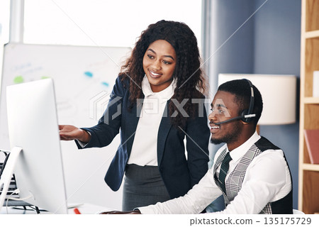Call center, black people training and with computer at desk in a office with the team coach. Telemarketing or communication, teamwork or collaboration and corporate colleagues discussing together Call center, black people training and with computer at desk in a office with the team coach. Telemarketing or communication, teamwork or collaboration and corporate colleagues discussing together 135175729