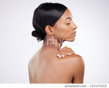 Woman, skincare and relaxed with back in studio for wellness, healthy glow and self care by white background. Indian model girl, skin health and soft touch with cosmetics, thinking and aesthetic 135175818