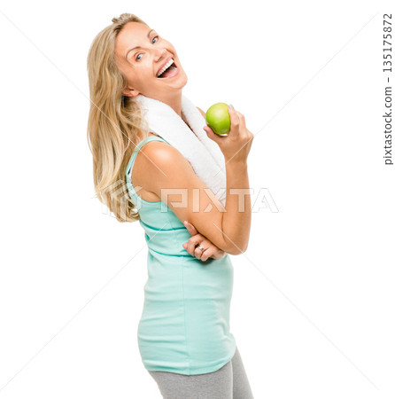 Portrait, exercise and apple with a senior woman laughing in studio isolated on a white background. Fitness, health or weightloss with a happy mature female athlete holding fruit for a nutrition diet 135175872