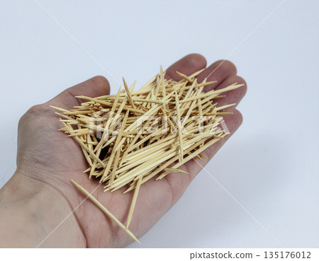 a bunch of toothpicks in the palm of the hand 135176012