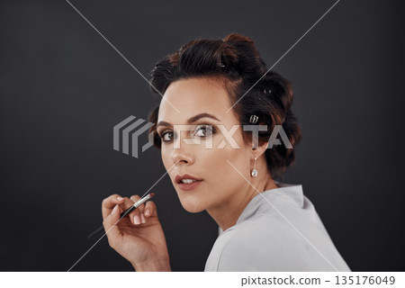 Beauty portrait, lip liner and woman with cosmetics application, natural skincare glow or facial makeup. Wellness, face and studio person with lips care, dermatology and prepare on black background 135176049