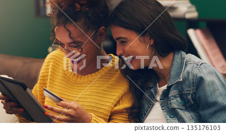 Girl friends, laugh and credit card with tablet on a living room sofa with online shopping. Student, happiness and young woman together with web purchase and ecommerce payment app on a home lounge Girl friends, laugh and credit card with tablet on a living room sofa with online shopping. Student, happiness and young woman together with web purchase and ecommerce payment app on a home lounge 135176103