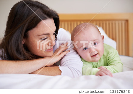 Mother, happy baby and relax bed for love, care and fun quality time together at home. Mom, cute newborn child and bonding in bedroom for support, happiness and joy for healthy development of infant 135176248