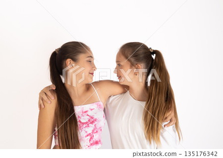 Two girls hugging each other 135176342