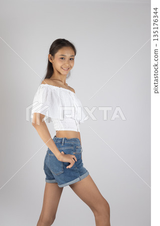 Woman in white top and denim shorts Woman in white top and denim shorts 135176344