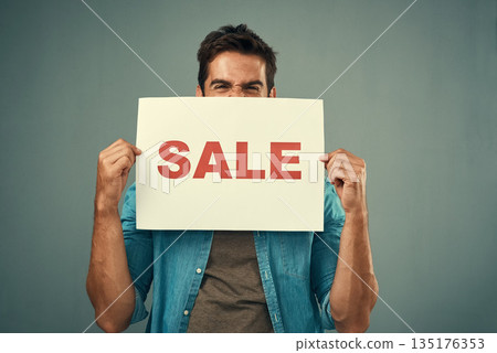 Man, hands and sale sign for advertising, marketing or branding against a grey studio background. Excited male person or model holding billboard or poster for sales, announcement or advertisement Man, hands and sale sign for advertising, marketing or branding against a grey studio background. Excited male person or model holding billboard or poster for sales, announcement or advertisement 135176353