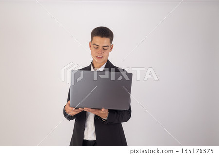 Businessman using laptop computer in suit 135176375