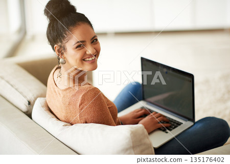 Happy woman in portrait, couch and laptop, typing for blog and freelance copywriter working from home. Female freelancer in living room, copywriting and writing on pc with technology and remote work 135176402