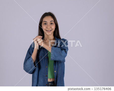Happy woman in a denim shirt hugging herself 135176406