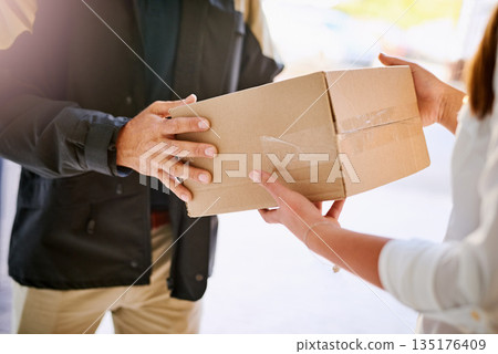 Customer, box and hands of delivery man giving courier company package at home. Logistics worker at front door of woman or client with a cardboard parcel for e commerce shipping or mail distribution 135176409