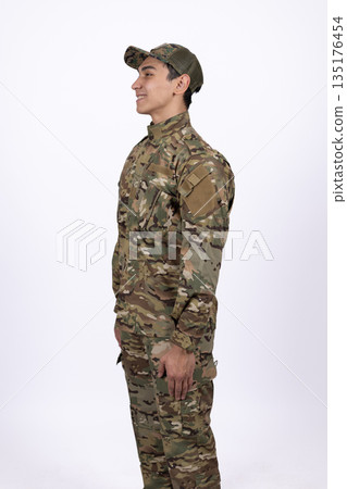 Soldier in military camouflage uniform standing Soldier in military camouflage uniform standing 135176454