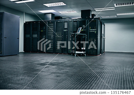 Server room, empty or hardware for internet networking connection, servers or cyber security system. IT support background, information technology electronics or machine equipment in data center Server room, empty or hardware for internet networking connection, servers or cyber security system. IT support background, information technology electronics or machine equipment in data center 135176467
