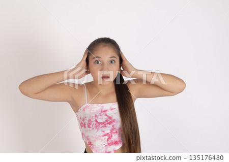 Girl holding hands on head Girl holding hands on head 135176480
