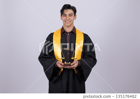 Happy graduate in robe holding award 135176482
