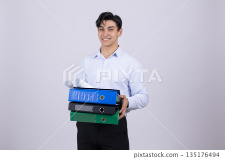 Man in blue shirt holding stack of folders Man in blue shirt holding stack of folders 135176494