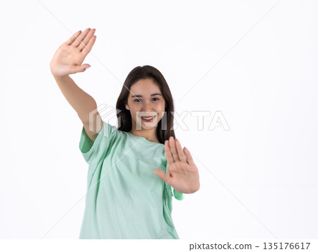 Girl in green t-shirt waving hand 135176617