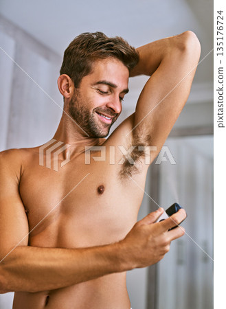 Deodorant, man or spray armpit after shower in home for hygiene, male grooming or perfume to control sweating. Happy shirtless guy cleaning underarm with fragrance cosmetics, body product or skincare 135176724