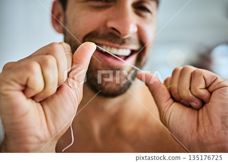 Hands, face and man floss teeth for smile, dental health and care for gum gingivitis at home. Closeup of happy guy, oral thread and cleaning mouth for fresh breath, tooth hygiene and healthy habit 135176725