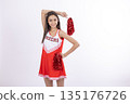 Cheerleader girl in a red skirt posing with pom-poms 135176726