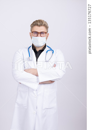 Confident male doctor in a white lab coat Confident male doctor in a white lab coat 135176727