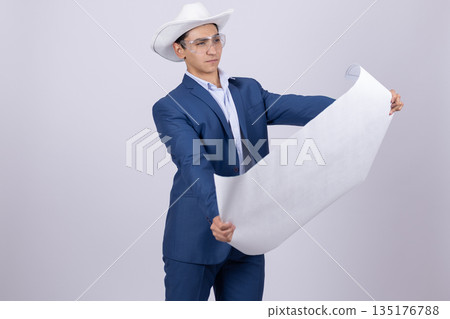 Man in a blue suit and hat holding a blueprint Man in a blue suit and hat holding a blueprint 135176788