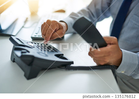 Hand, telephone and business man dial a number at work or on desk or call centre for customer service and In the office. Employee, telemarketing and receptionist or consulting and communication Hand, telephone and business man dial a number at work or on desk or call centre for customer service and In the office. Employee, telemarketing and receptionist or consulting and communication 135176812