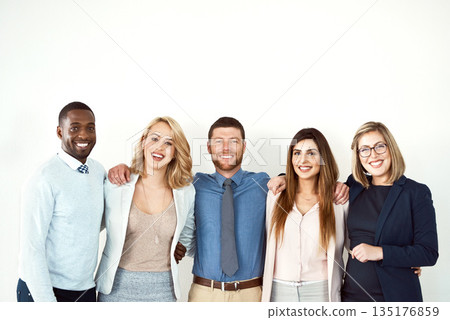 Collaboration, portrait and smile of lawyers by white wall background or mockup in workplace. Confident face, law group and business people standing together with teamwork, diversity and cooperation. 135176859