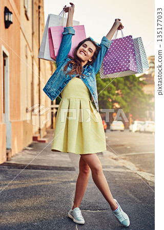 Excited, portrait and woman with bags from shopping, retail therapy and sale in the city. Smile, freedom and a young lady with happiness from fashion deal, sales and winning with a spree in town Excited, portrait and woman with bags from shopping, retail therapy and sale in the city. Smile, freedom and a young lady with happiness from fashion deal, sales and winning with a spree in town 135177033