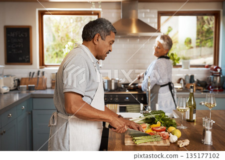 Cooking, vegetables and old man with woman in kitchen, happiness and healthy bonding time in home. Marriage, love and food, senior couple with meal prep for vegetable dinner with retirement wellness. Cooking, vegetables and old man with woman in kitchen, happiness and healthy bonding time in home. Marriage, love and food, senior couple with meal prep for vegetable dinner with retirement wellness. 135177102