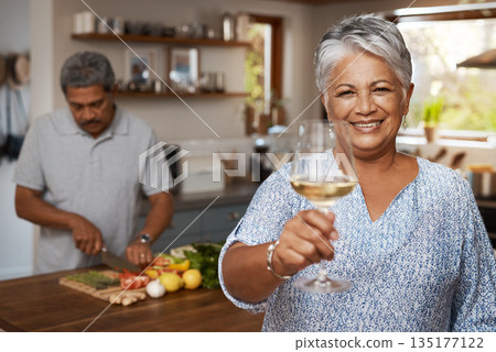 Portrait of old couple in kitchen, wine and cooking, cheers to healthy food together in home. Toast, smile and senior woman with glass in house with man, meal prep and happy lunch diet in retirement 135177122