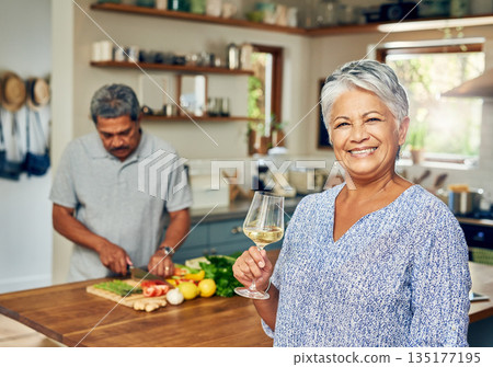 Portrait of old woman in kitchen with man, wine and cooking healthy food together in home. Bonding, smile and senior couple in house with meal prep, happiness and drinks to relax in retirement time. Portrait of old woman in kitchen with man, wine and cooking healthy food together in home. Bonding, smile and senior couple in house with meal prep, happiness and drinks to relax in retirement time. 135177195