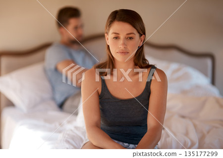 Sad, upset and couple in an argument in their bedroom for divorce or breakup in a modern house. Toxic, mad and face of a woman fighting and in conflict with her boyfriend in bed in their home. Sad, upset and couple in an argument in their bedroom for divorce or breakup in a modern house. Toxic, mad and face of a woman fighting and in conflict with her boyfriend in bed in their home. 135177299