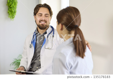 Medical support and care of doctor to woman patient at consultation in hospital Medical support and care of doctor to woman patient at consultation in hospital 135178183