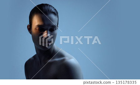 Male upper body portrait with soft blue light and shadows. Male upper body portrait with soft blue light and shadows. 135178335