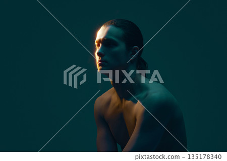 Male portrait with wet hair on teal background looking forward. Male portrait with wet hair on teal background looking forward. 135178340