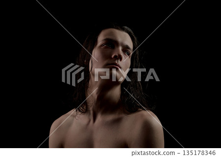 Male portrait with wet hair in dramatic low light studio. Male portrait with wet hair in dramatic low light studio. 135178346
