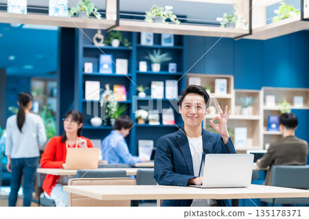 Middle-class engineer working in an office 135178371