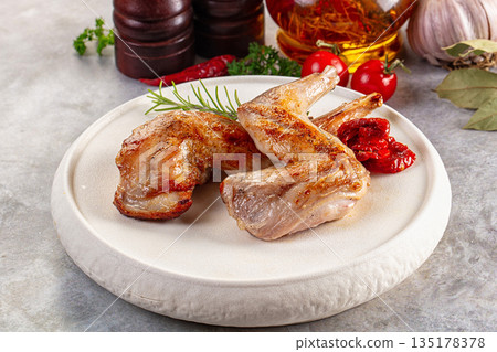 Roasted rabbit leg served rosemary Roasted rabbit leg served rosemary 135178378