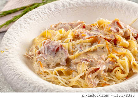 Italian pasta fettuccine with prosciutto 135178383