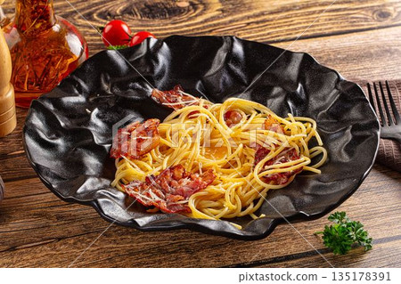 Italian classic spaghetti carbonara with bacon and egg 135178391