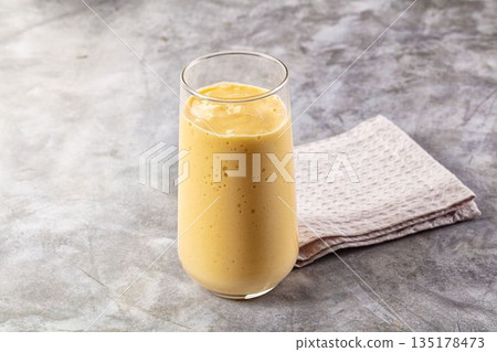 Sweet mango smoothie dessert glass 135178473